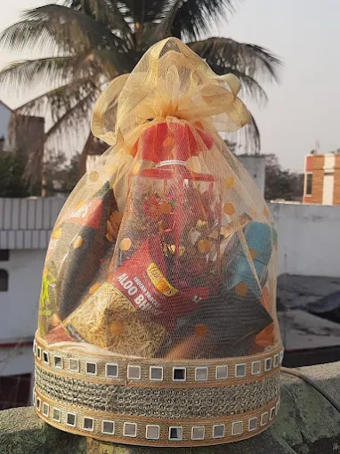 Golden potli gift hamper with chocolates and dry fruits for him