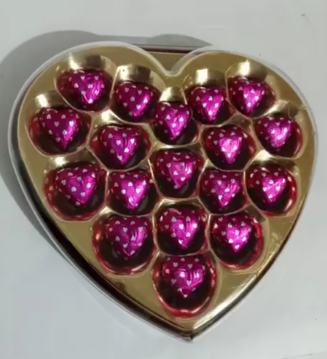 Heart shaped box with pink foil heart chocolates for girlfriend
