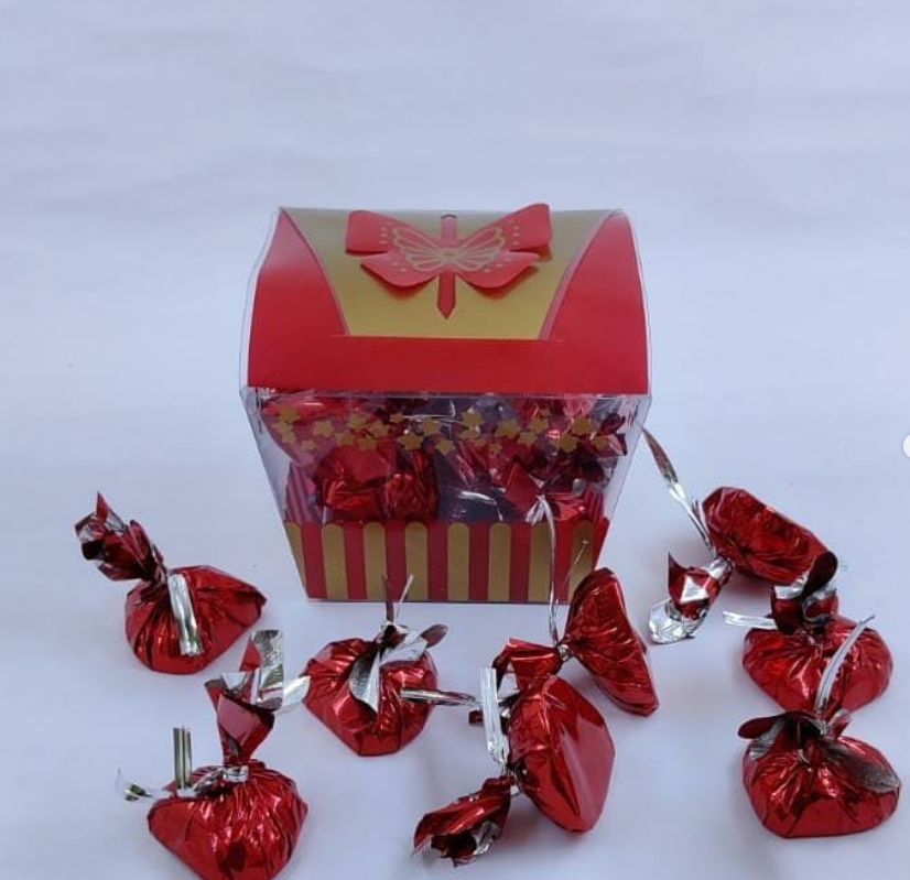 Red and gold gift box with foil-wrapped handmade chocolates