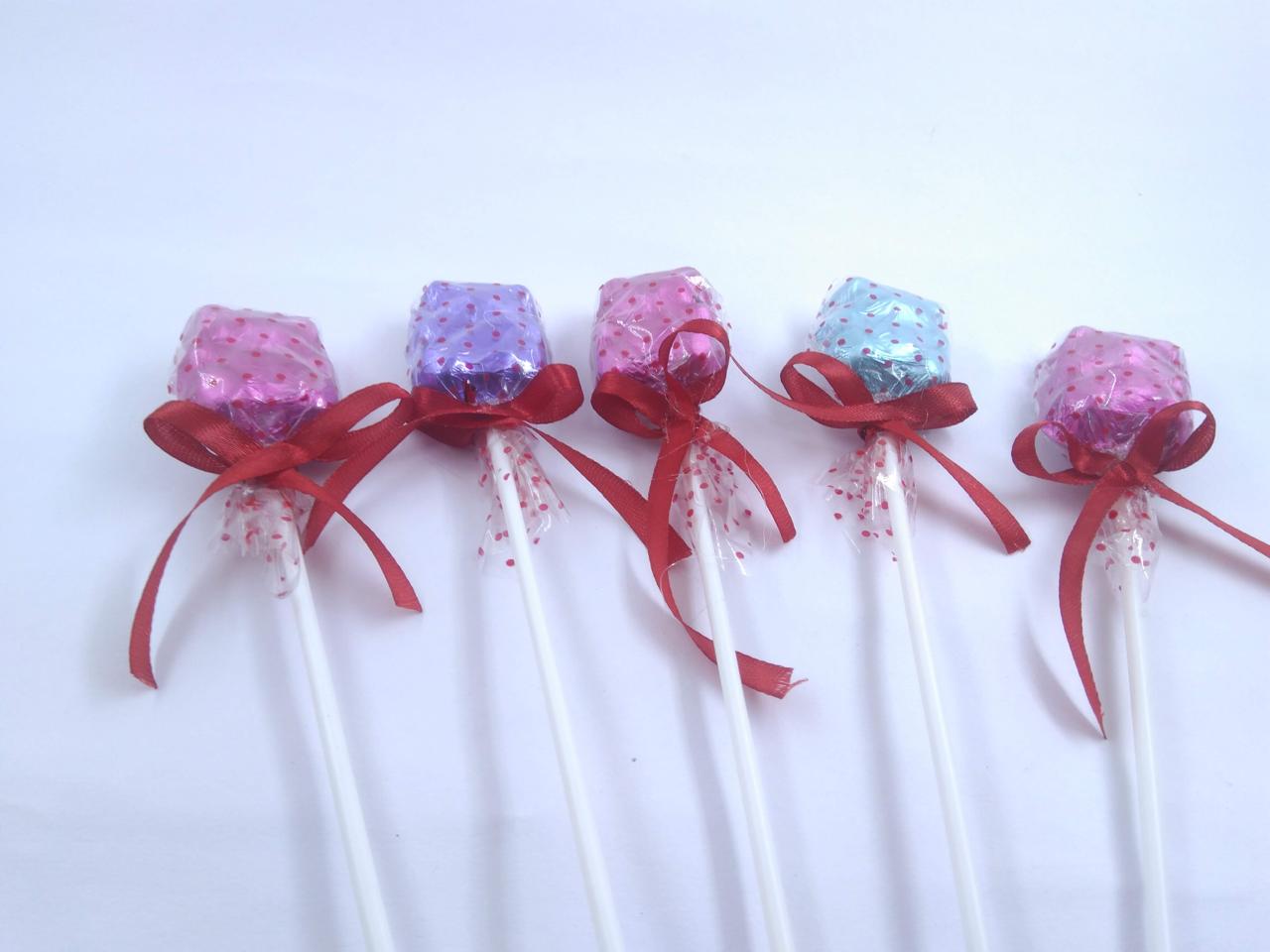 Colourful foil wrapped chocolate welcome lollipops with ribbons